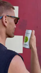 A 'get ready with me' style video featuring a man preparing for a gym session, incorporating the consumption of Spraga Kombucha as part of his routine.