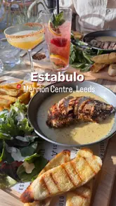 A promotional montage showcasing the opening of a new Estabulo restaurant in Leeds. The video features exterior shots, the interior dining space, a cocktail, and various grilled meat dishes and desserts.