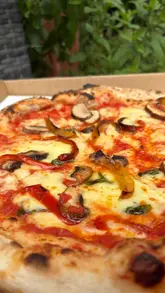 A creator visits a hidden backyard pizza pop-up in Barry, showcasing the preparation process and the final product.