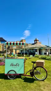 A short, montage-style video showcasing 'Herbs' at the Old Course Hotel in St Andrews. The video features shots of the cafe's exterior, interior, and menu items, including a salmon croissant and matcha, set to music with text overlays.