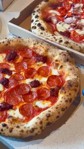 A creator visits Uno Pizza in Rathmines to review their food and highlight the convenience of the Ultra Order app. The video features shots of the restaurant exterior, the kitchen staff preparing pizzas, and close-ups of the finished dishes, interspersed with the creator's commentary.