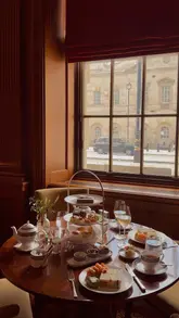 A cinematic showcase of an espionage-themed afternoon tea at Raffles London at The OWO, featuring detailed shots of themed pastries, the elegant dining room, and the historic venue setting.