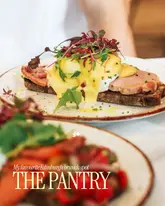 A high-quality, appetizing close-up shot of an Eggs Benedict dish, likely taken at a brunch venue. The image uses a shallow depth of field to focus on the food, creating a professional and inviting aesthetic suitable for social media promotion.