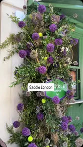 A montage video showcasing the interior, floral decor, merchandise, and food menu of Saddle London, a cafe in Knightsbridge.