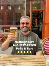 A bright, well-composed lifestyle shot featuring a man holding a pint of beer at an outdoor table, used as a cover image for a listicle about Nottingham's highest-rated pubs and bars.