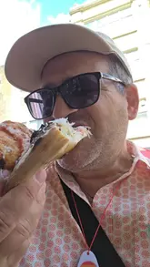 A creator visits a pizza street food stall in London during Pride, providing a personal recommendation and showing the product.