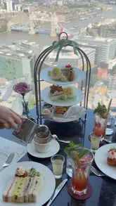 A short, aesthetic reel showcasing a Wimbledon-themed afternoon tea at TĪNG Restaurant in the Shangri-La, The Shard, featuring tennis-inspired pastries, finger sandwiches, and cocktails against a backdrop of the London skyline.