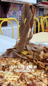A short video review of 'Get Stuffed,' a takeaway shop in Newcastle. The video features a tour of the exterior and interior, highlights the menu options, and showcases the food, specifically a pizza and kebab combo.