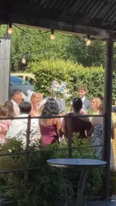 A high-energy video capturing a wedding reception at Yardspace Old Gore, featuring a performance by singing waiters. The guests are actively participating, creating a lively and memorable atmosphere.