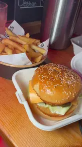 A montage of a group enjoying a bottomless brunch at a venue, featuring drinks, burgers, and a lively party atmosphere with sports screens visible.