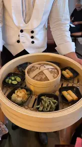 A review of the Dim Sum Dynasty Brunch at MiMi Mei Fair in London, featuring a variety of dim sum dishes, cocktails, and the restaurant's elegant interior.