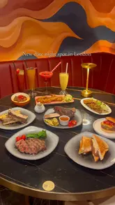 A montage showcasing a variety of dishes including beef ribs, burgers, and steaks, alongside interior shots of a modern, stylish restaurant in London.
