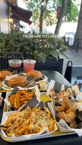 A short, fast-paced promotional video for a burger restaurant called G.O.A.T. in London. The video features quick cuts of various menu items including burgers, loaded fries, and chicken wings, interspersed with shots of the restaurant's bright yellow and white interior.