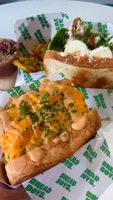 A review of a new sandwich shop in Belfast called Bread Boys, showcasing their menu, interior, and specific items like the Caesar sandwich and iced coffee.