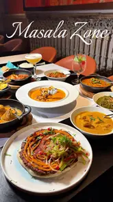 A cinematic montage showcasing the interior of Masala Zone and a variety of Indian dishes, highlighting the restaurant's opulent decor and the 'Grand Trunk Road Odyssey' menu.