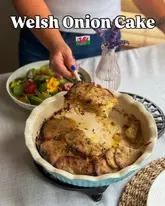 A bright, well-lit, and inviting shot of a homemade Welsh onion cake being served. The image effectively showcases the texture of the dish and uses natural lighting to create an appealing, rustic aesthetic.