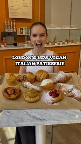 A vibrant and informative reel featuring a visit to a new vegan Italian patisserie in London. The creator provides a tour of the shop and the kitchen, highlights the technical skill involved in vegan baking, and samples a variety of pastries, including cruffins, cannoli, and cinnamon buns.