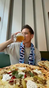 A promotional video for Rudy's Pizza featuring a limited-edition football scarf collaboration with Poretti beer, offering a free pint to diners who wear the scarf.