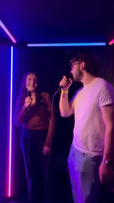 The video features a group of friends enjoying a night out at Golf Fang, highlighting the venue's combination of food, drinks, and competitive socialising activities including crazy golf, AR darts, and karaoke pods.