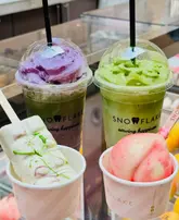 A bright, clear promotional shot of various gelato products, including lollies and cups, from Snowflake Gelato. The image effectively showcases the vibrant colours and textures of the desserts, making them look refreshing and appealing for a hot day.