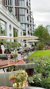 A visually appealing, polished showcase of the Secret Summer Garden at the Mandarin Oriental Hyde Park, highlighting the elegant outdoor setting, cheese board, and dessert selection.