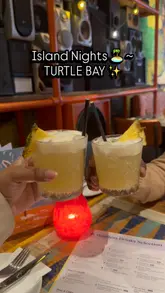 A short, fast-paced video showcasing a visit to Turtle Bay, highlighting their Island Night bottomless drinks package and a variety of dishes including mac and cheese, wings, and shrimp.