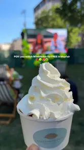 A short video showcasing a free Wimbledon screening event in Hanover Square, London, featuring a Mandarin Oriental pop-up stall serving strawberries and cream and soft-serve ice cream.