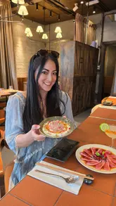 A video showcasing a lunch date at a restaurant called Fan, highlighting their Nikkei tasting menu. The footage includes shots of the interior, the sushi counter, chefs preparing dishes, and close-ups of the food and cocktails.