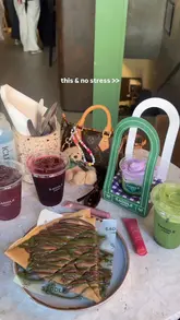 A short, aesthetic montage showcasing various drinks and a crepe at Saddle London, emphasizing the visual appeal of the products and the cafe's location near Harrods.