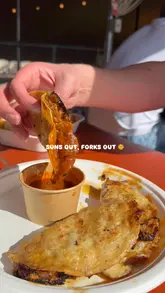 A short, upbeat montage showcasing a variety of street food dishes and drinks at an outdoor venue, capturing a relaxed, sunny atmosphere.