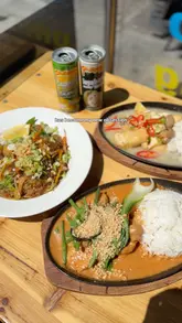 A short video review showcasing three Filipino dishes at a restaurant in Bristol. The video features close-up shots of sizzling plates and noodles, with text overlays describing the food.