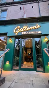 A polished, visually appealing montage showcasing the interior, wine selection, and various dishes at Gillson's Brasserie, including starters, mains, and desserts.