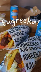 A simple unboxing video of a Greek takeaway order, showcasing various dishes including loaded fries, souvlaki, and desserts.