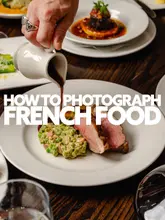 A professional, high-quality food photography shot demonstrating a sauce pour over a meat dish, used as an educational post about food photography techniques.