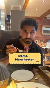 A short, polished video review of Damo, an Italian restaurant in Manchester. The video features close-up shots of pasta and carpaccio dishes, the restaurant's interior, and the creator enjoying the meal, followed by an exterior shot of the venue.