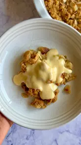A recipe tutorial video where the creator demonstrates the process of developing an almond croissant apple crumble, testing different toppings and sharing the results.