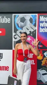 A high-energy vlog showcasing a YouTube Creator Collective event held at Boxpark Croydon during a World Cup screening. The video features the creator participating in various activations, including face painting and nail art, browsing merchandise, and enjoying the atmosphere of the football screening with a crowd.