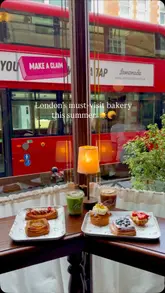 A montage video showcasing various pastries, including fruit-topped danishes and signature croissants, alongside iced matcha and lattes at Fred Bakery in London. The video features close-up shots of the food and drinks, highlighting the aesthetic presentation and the bakery's interior.