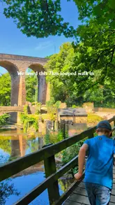 A family-oriented travel reel documenting a 7km walking loop in New Mills, Peak District. The video highlights scenic canal and riverside paths, the Millennium Walkway, a lunch stop at Torrs Vale Tap, and recreational areas like Rock Mill Visitor Centre and High Lea Park.