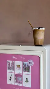 A short, aesthetic video showcasing the new location of Rise, a cafe in York. The video highlights their menu items, including açaí bowls and specialty iced lattes, as well as a unique in-store vending machine selling local art prints.