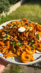 A home cooking tutorial demonstrating how to prepare a vegan kebab meal using frozen twister fries in an air fryer.