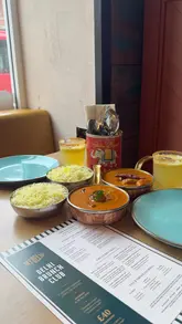 A creator visits My Delhi in Sunderland to review their new Brunch Club menu. The video features a walkthrough of the experience, including the welcome snacks, the curry feast, and the accompanying drink journey, all presented in an enthusiastic and informative vlog style.
