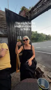 A short, engaging video highlighting a tiny, four-seat pizza pop-up located in the garden of Hatch Bakery in Barry. The video features the creators enjoying fresh pizza, wine, and sides in an intimate, relaxed outdoor setting, effectively conveying the unique 'smallest restaurant' concept.