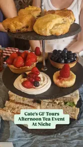 A vlog-style video documenting an afternoon tea event hosted by Cate's GF Tours at Niche restaurant in Angel, featuring a variety of gluten-free food items.