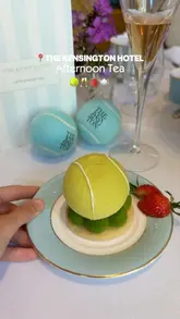 A short, engaging reel showcasing a Wimbledon-themed afternoon tea at The Kensington Hotel. The video features close-ups of the themed pastries, sandwiches, and champagne, alongside shots of the venue and the creator enjoying the experience.
