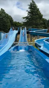 A short montage video showcasing two outdoor lidos in the UK, Aldershot Lido and Guildford Lido, highlighting their water slides as a destination for summer days out.