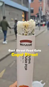 A fast-paced listicle video highlighting five different street food vendors on Capel Street in Dublin. The creator visits each location, showing the storefront and taking a bite of a signature item, including sushi pops, boreks, corn dogs, cookies, and avocado-shaped ice cream.