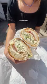 Two creators visit a sandwich pop-up called Granny G's located at the Green Room in Leeds. They showcase the menu, the venue's outdoor terrace, and review two of their sandwiches: the Chicken Caesar and the Shrimp Po Boy. The video is a high-energy, informative review that highlights the quality and portion size of the food.