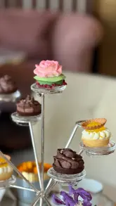 A montage of high-quality, cinematic shots featuring the interior, table settings, and food presentation of an afternoon tea service at a luxury hotel venue.