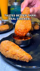 A fast-paced food review video showcasing a variety of vegetarian mock meat dishes, including chicken and lamb alternatives, at a restaurant in Leicester. The video focuses on close-up shots of the food's texture and presentation.
